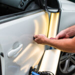 Repairing car dent after the accident by paintless dent repair